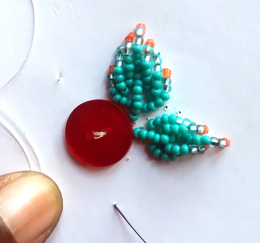 Two five-point leaves in turquoise beads