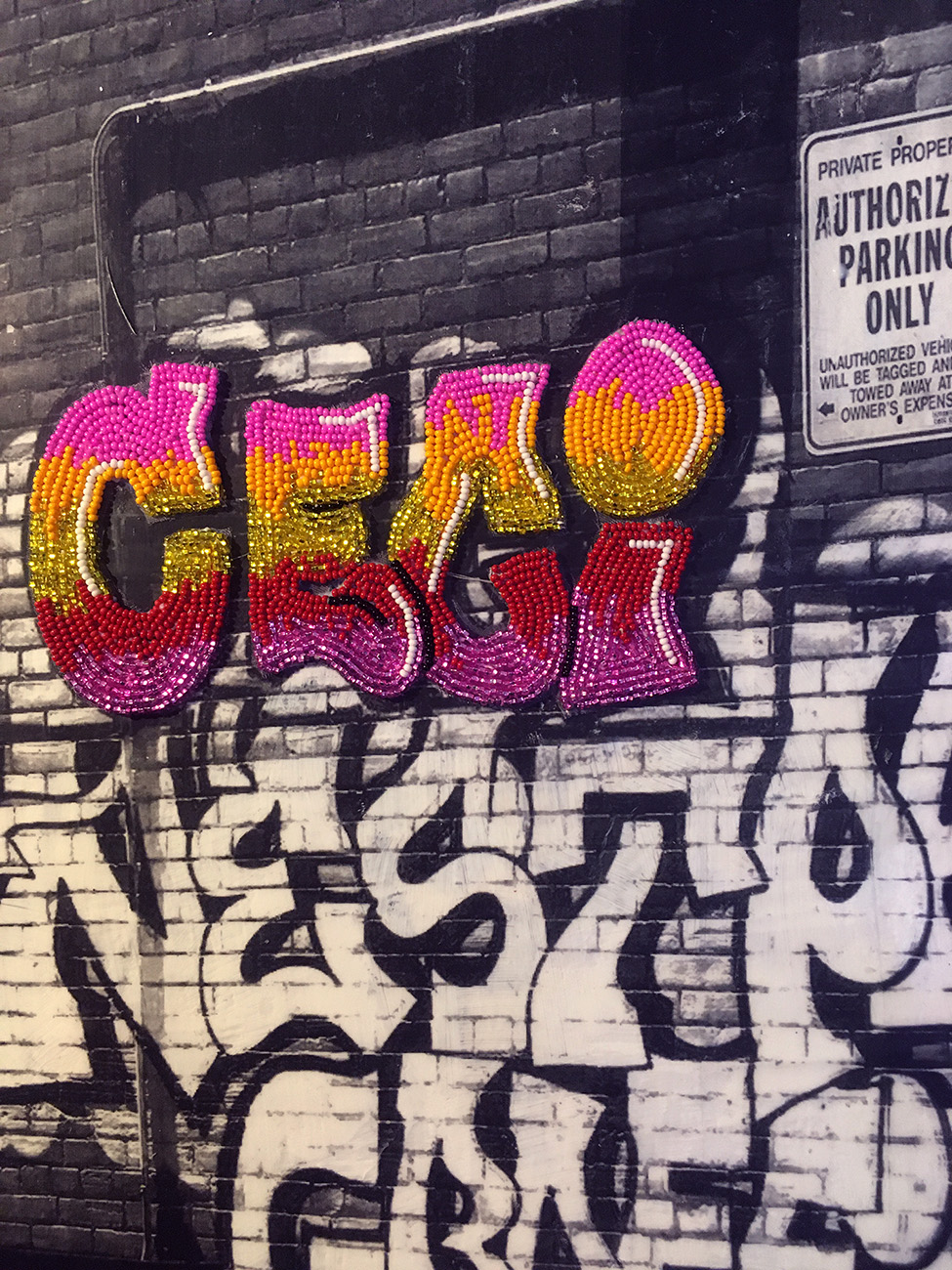 Close up of beaded graffiti of the French word 'ceci' on photo transfer
